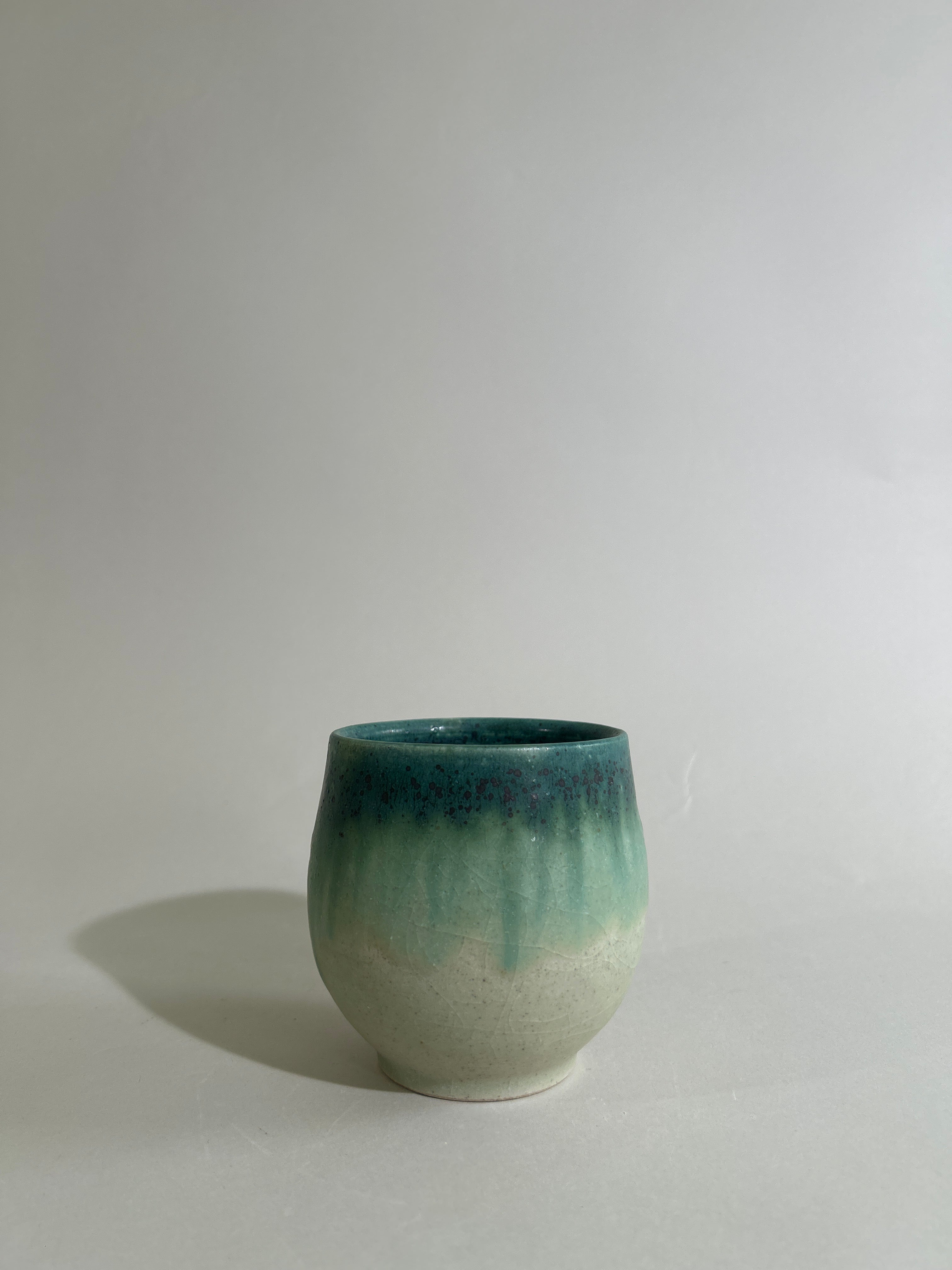 Green and stoneware cup