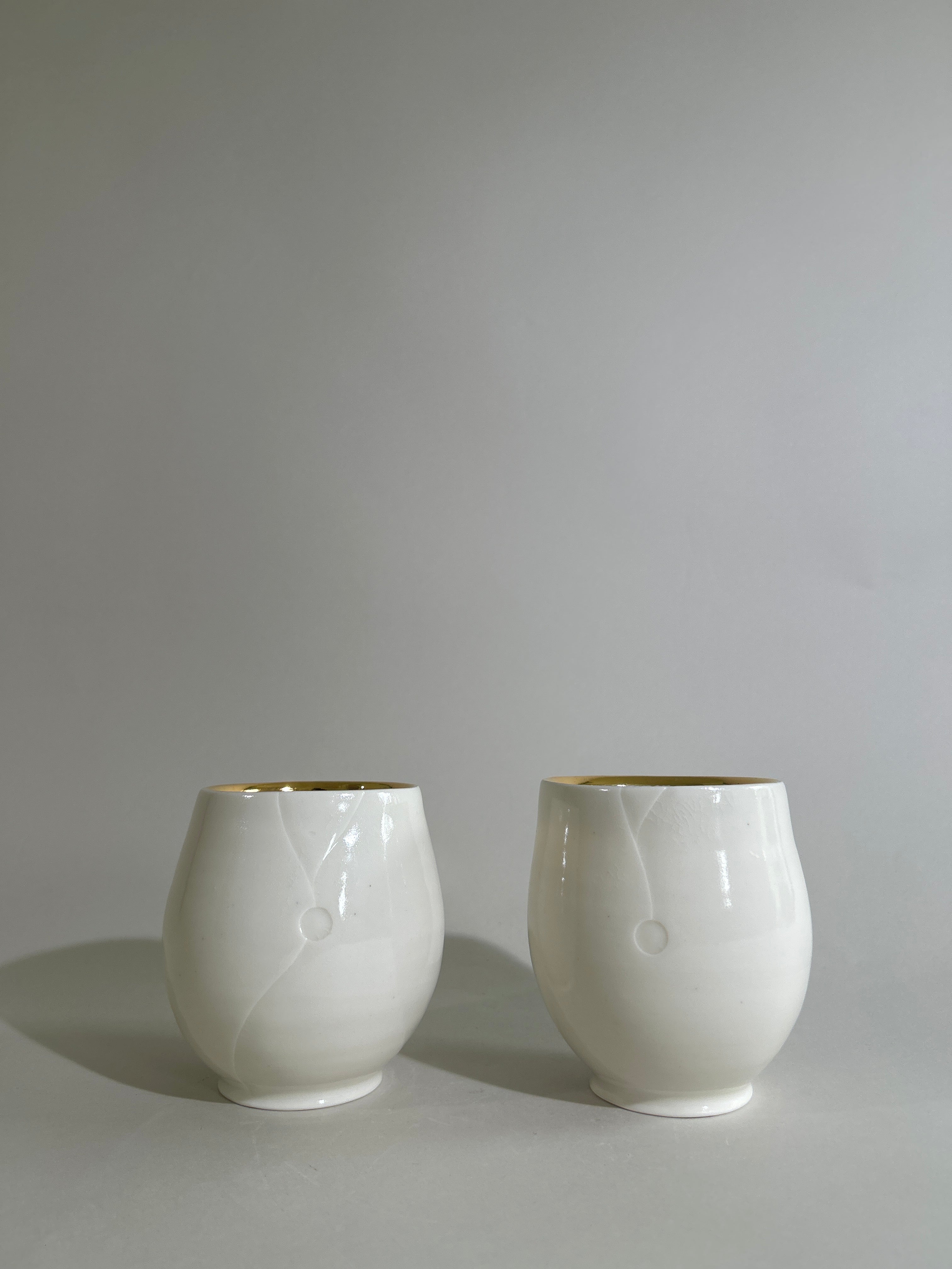 Carved porcelain cup with gold luster